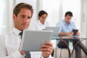 people on computers and tablets on office